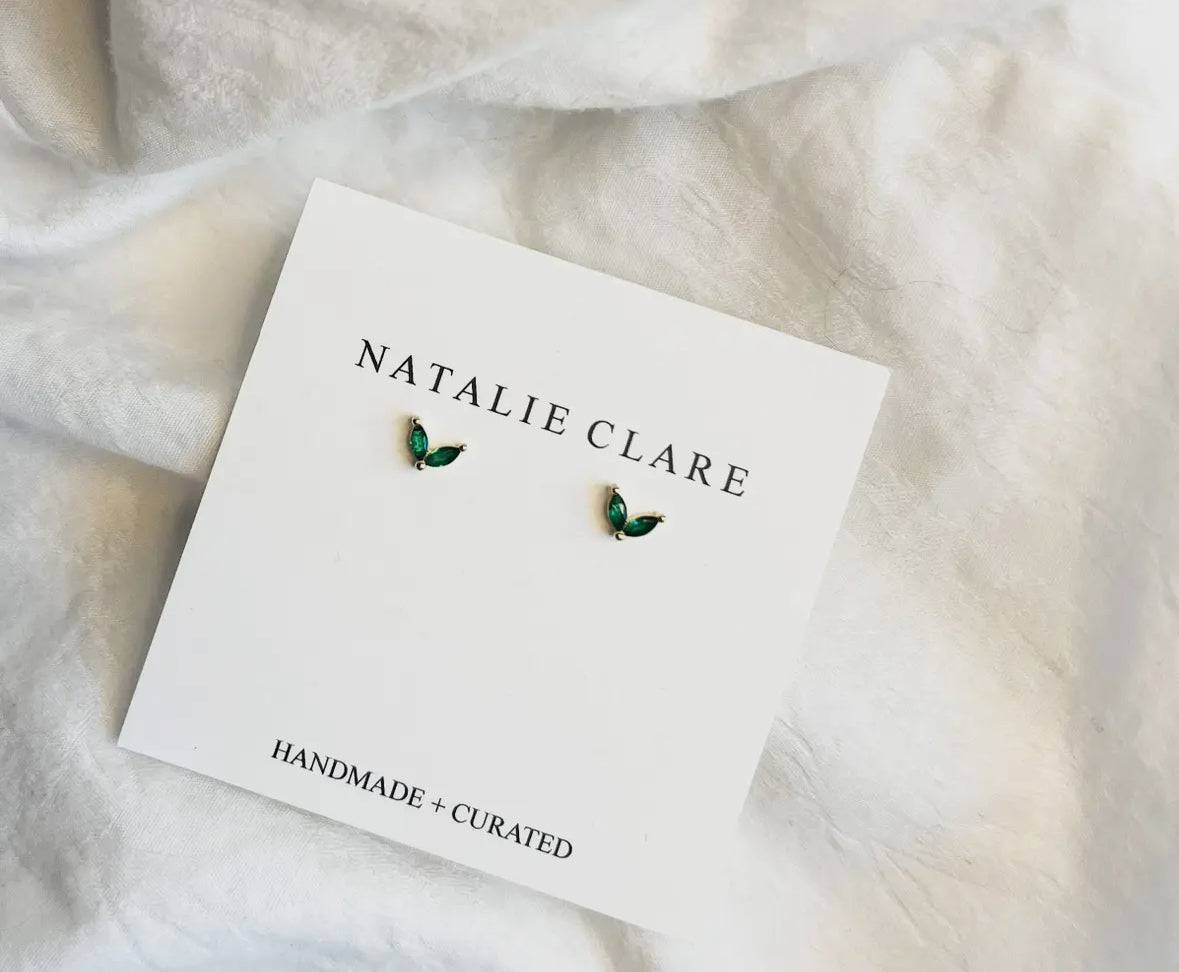 Natalie Clare earrings on a branded card with white fabric background