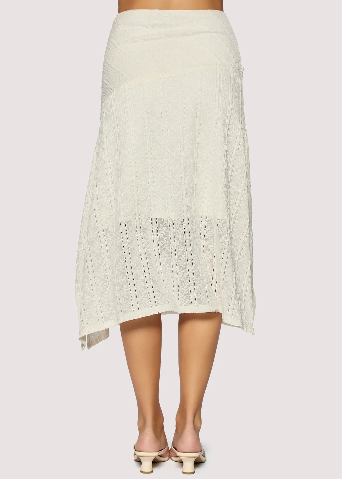White knit skirt worn by a person on a white background