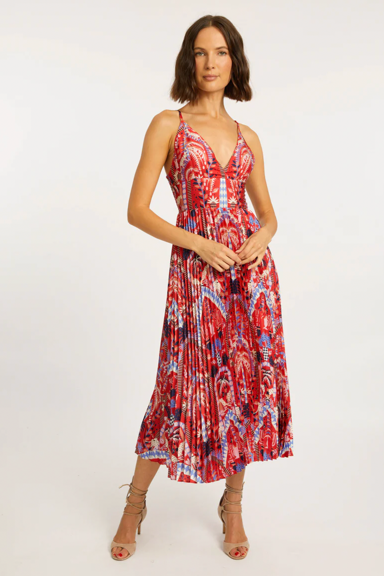 Woman wearing a red and blue patterned dress on a white background