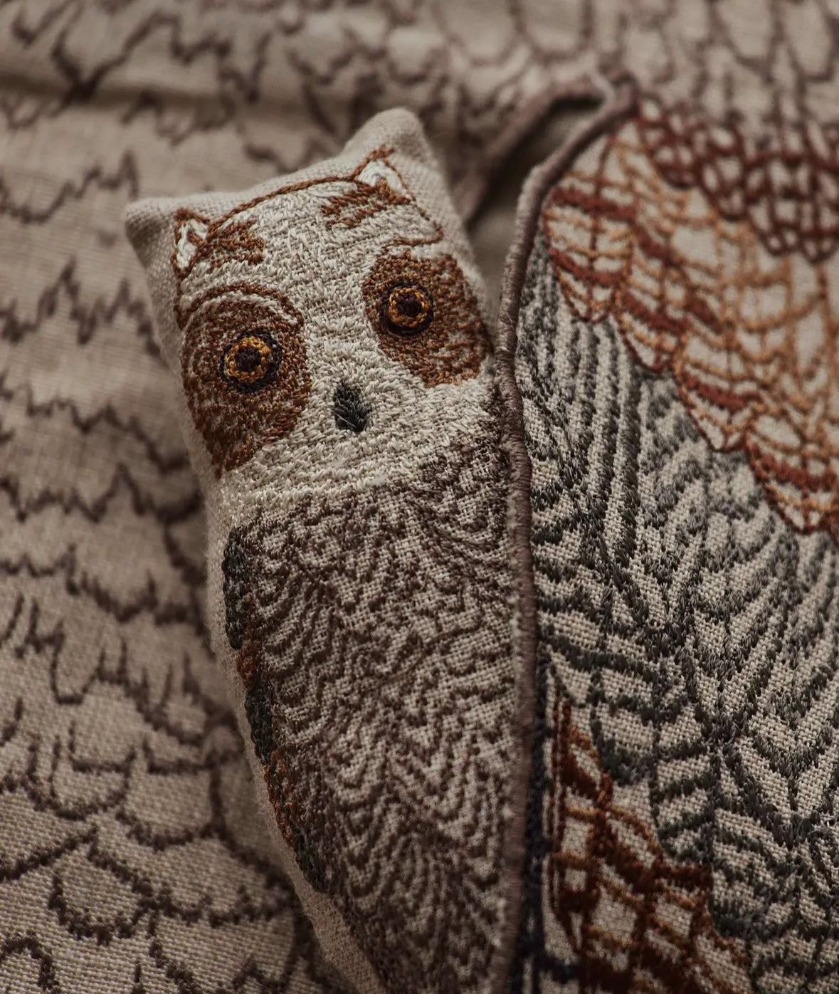 Owl-patterned fabric with a close-up of an owl face design.