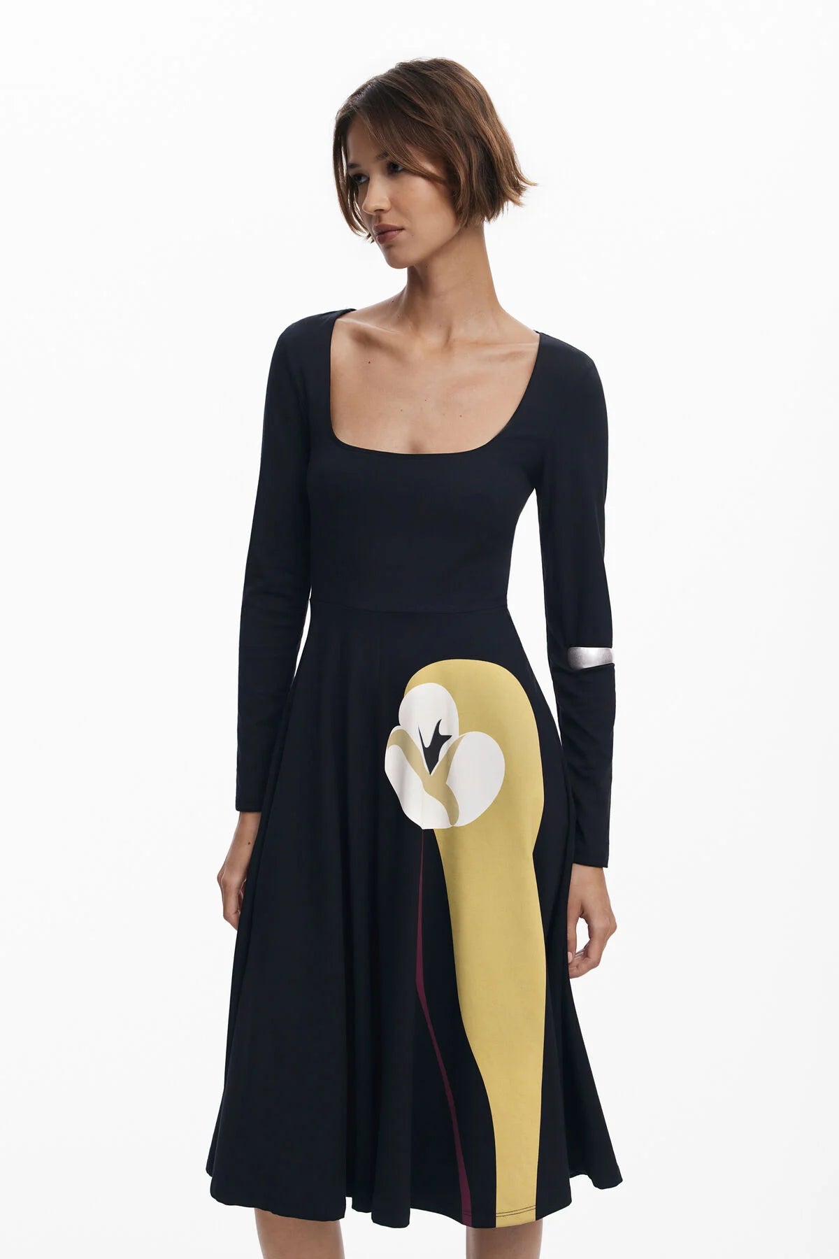 Black dress with a large yellow bird design on a white background