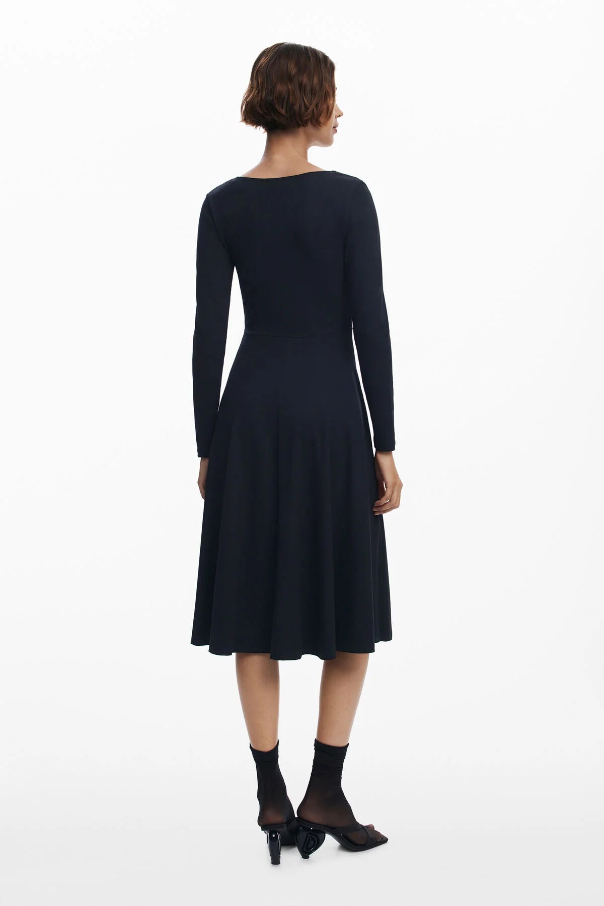 Woman wearing a black dress on a white background