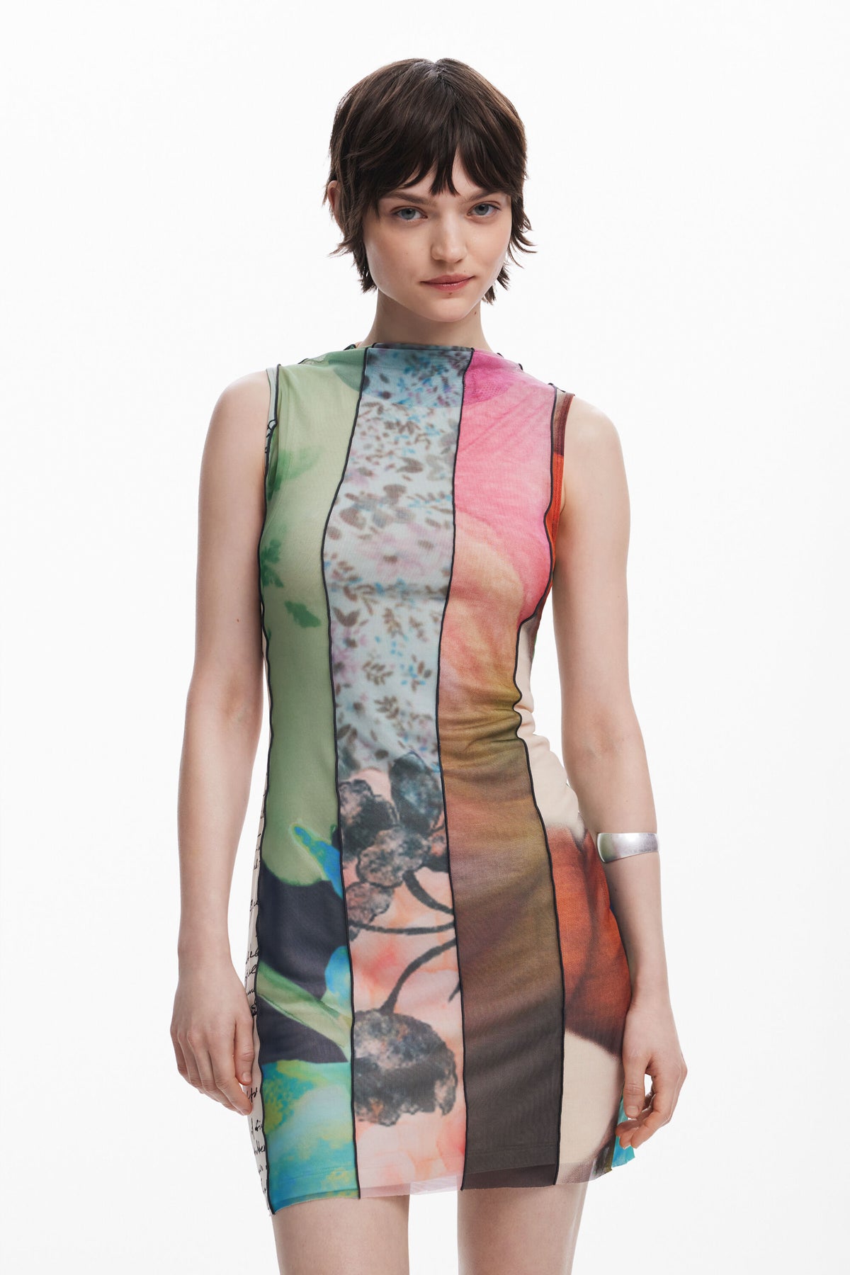 Woman wearing a colorful sleeveless dress with abstract patterns on a white background