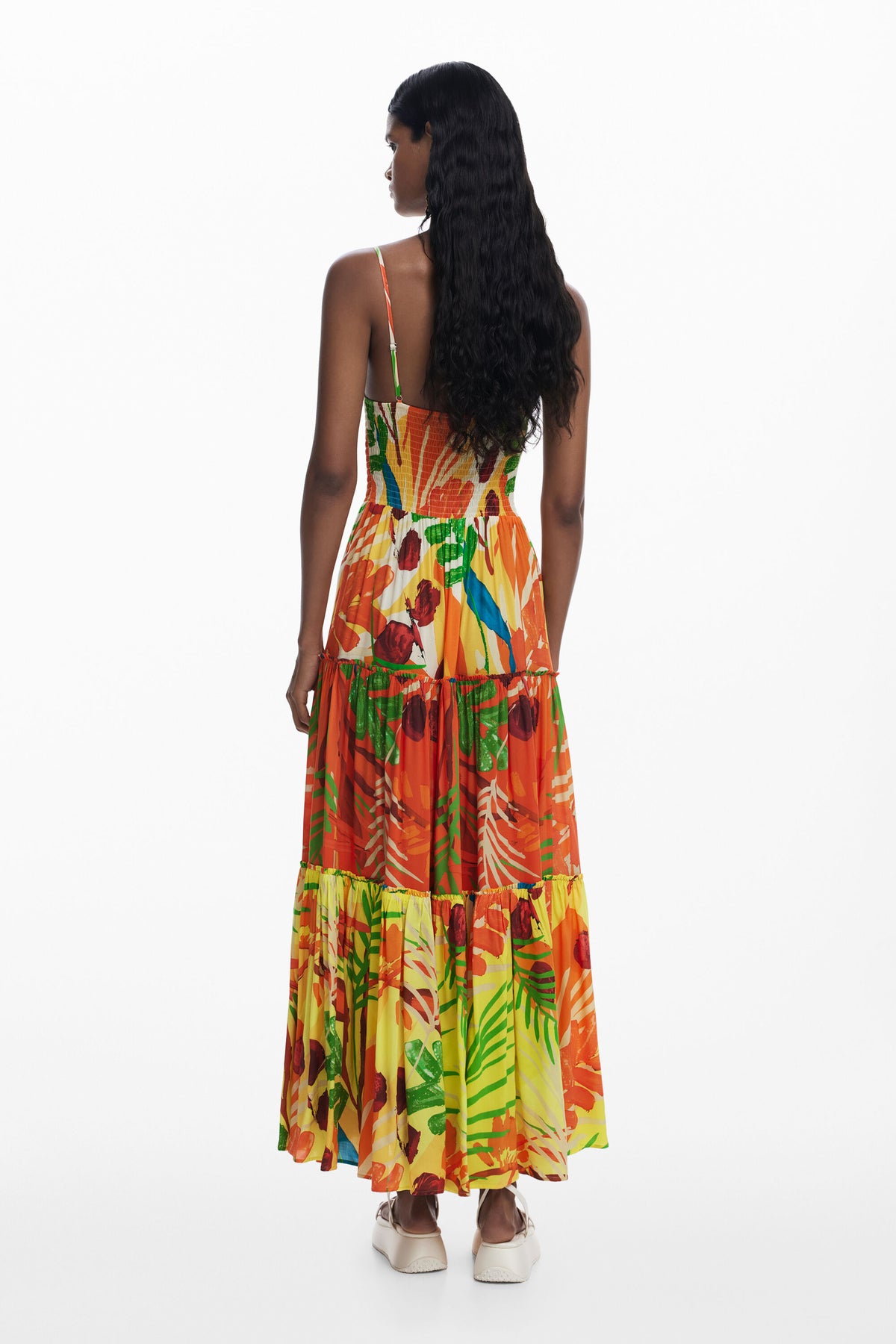 Woman wearing a colorful floral dress on a white background