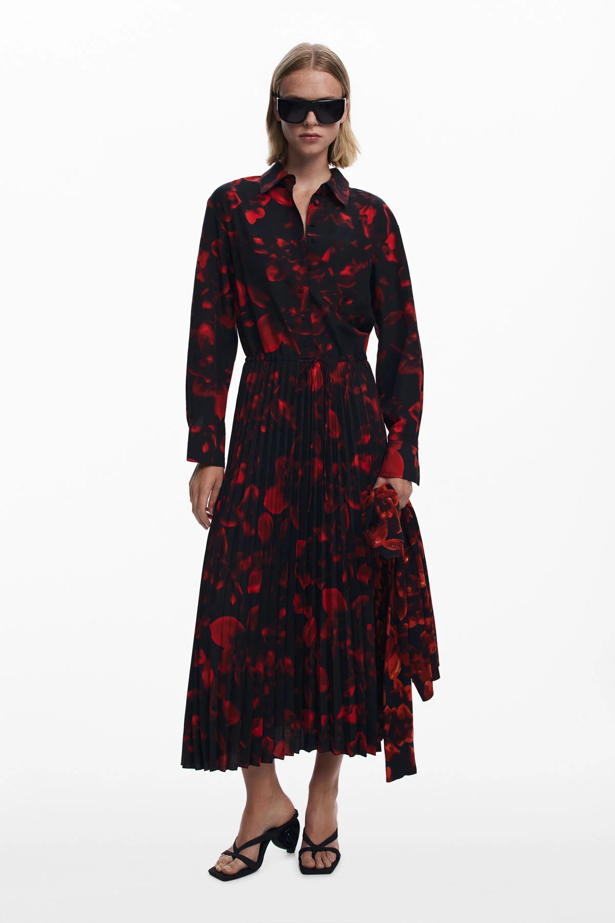 Woman wearing a black and red floral dress on a white background