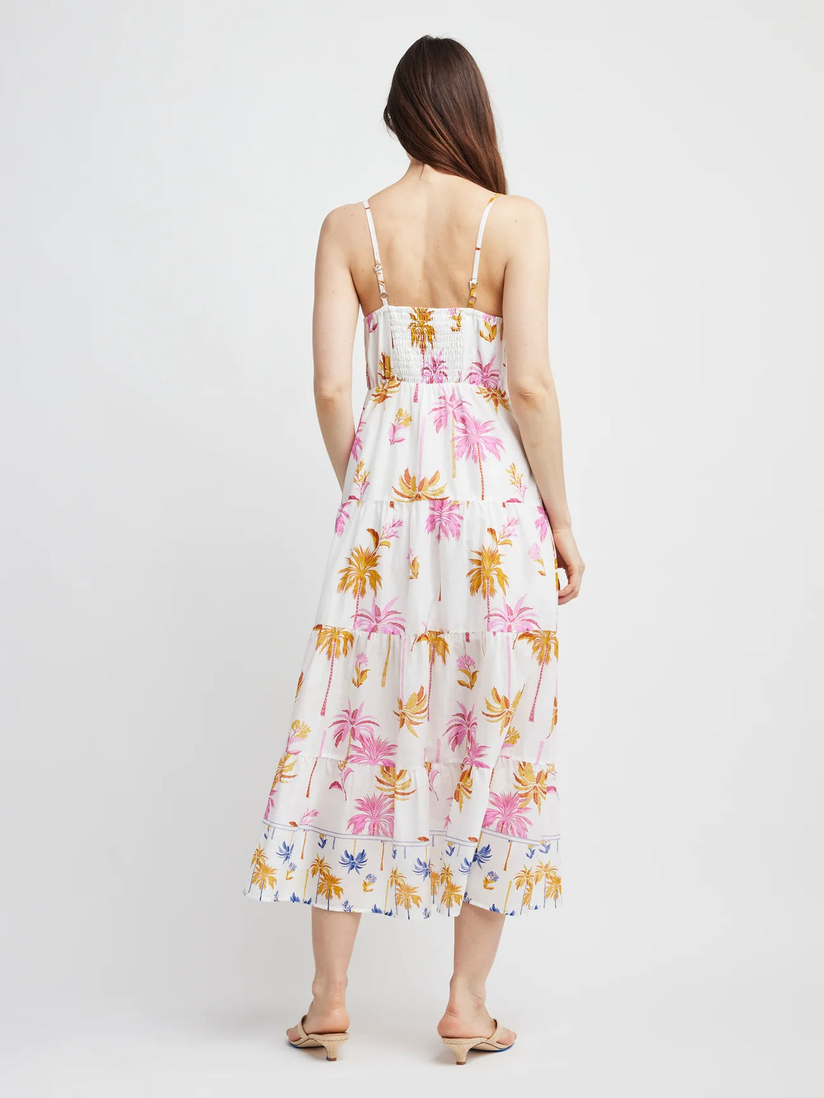 Woman wearing a floral dress with a white background