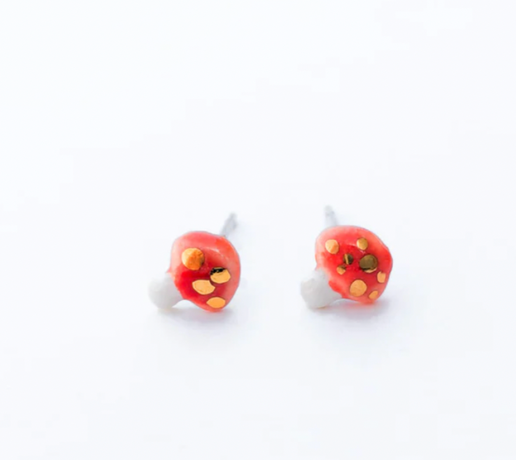 Red and yellow ladybug earrings on a white background