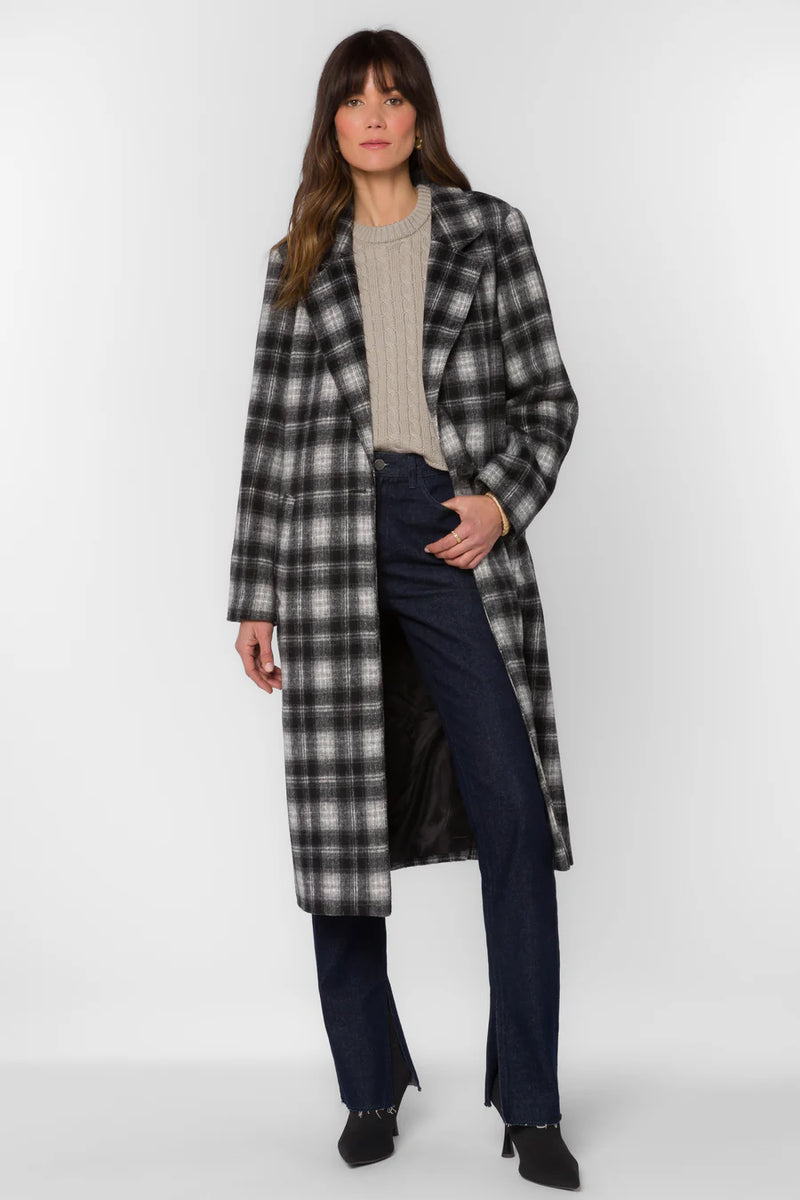 Woman wearing a plaid coat on a white background