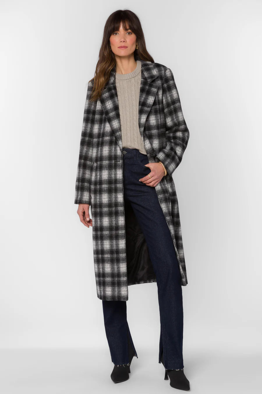Woman wearing a plaid coat on a white background