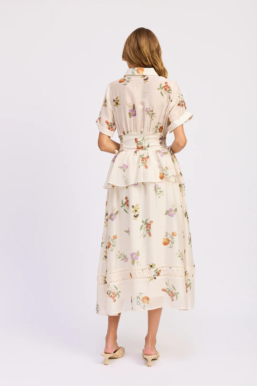 Woman wearing a floral dress on a white background