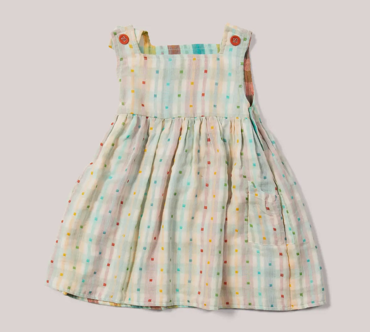 Children's dress with colorful polka dot pattern on a light background