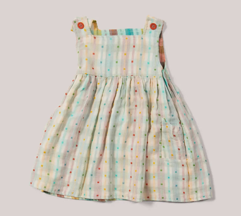 Children's dress with colorful polka dot pattern on a light background