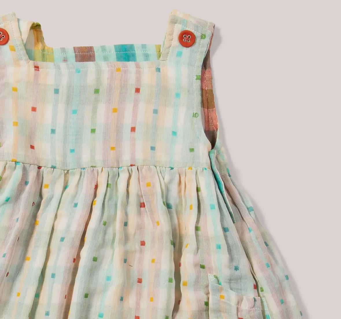 Colorful polka dot dress on a plain background