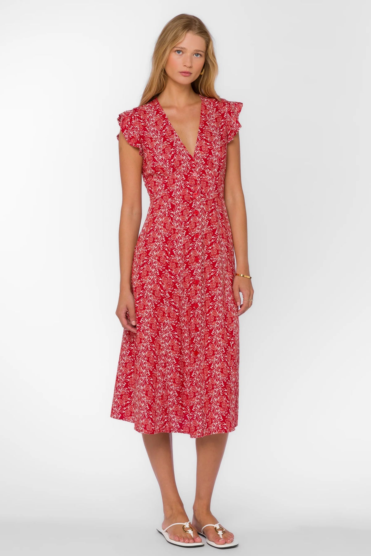 Woman wearing a red floral dress on a white background