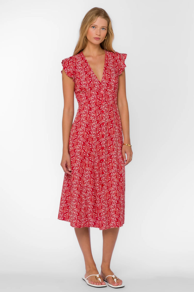 Woman wearing a red floral dress on a white background