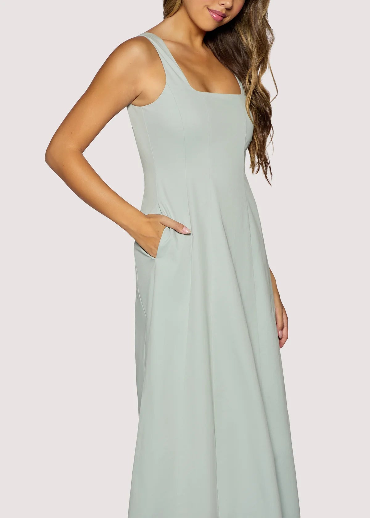 Woman wearing a light blue dress against a plain background