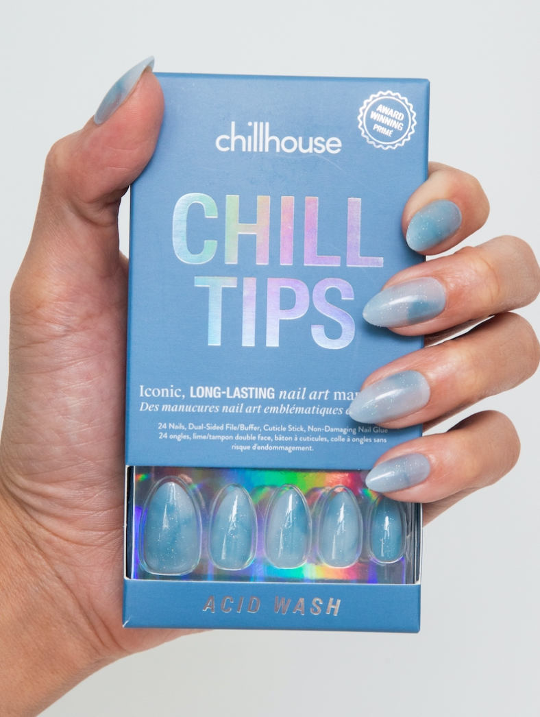 Hand holding a box of 'Chill Tips' nail art masks with matching nails.