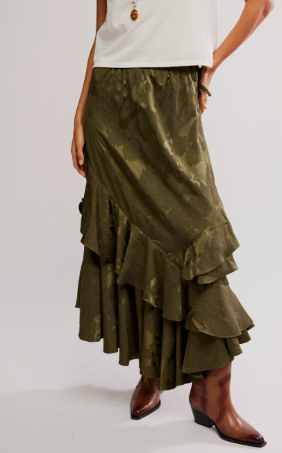 Green tiered skirt worn by a person on a white background