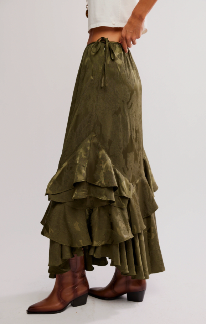 Green layered skirt worn by a person on a white background