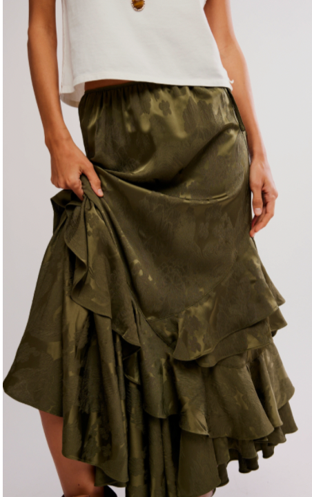 Green tiered skirt worn by a person on a white background