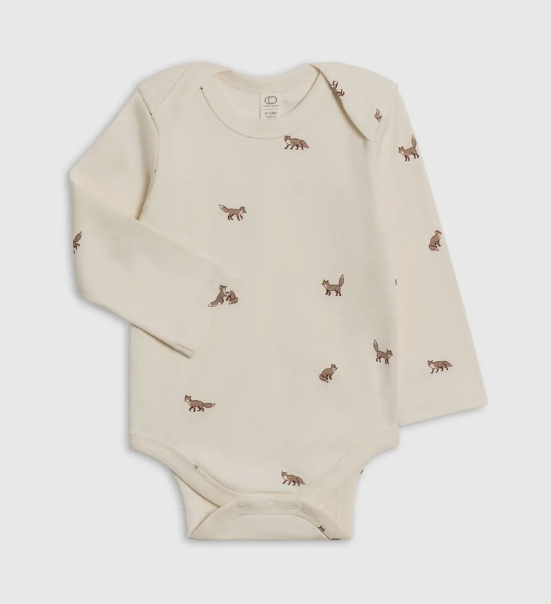 Beige baby onesie with small animal prints on a light gray background