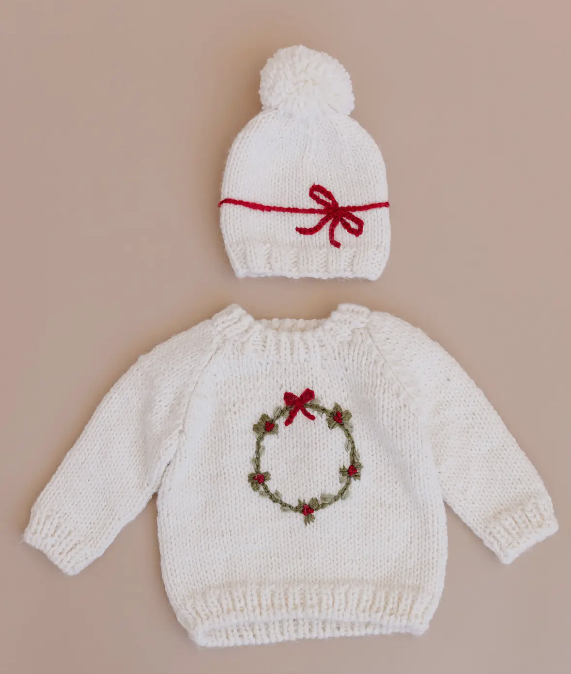 Knitted baby sweater with festive wreath and hat set. 