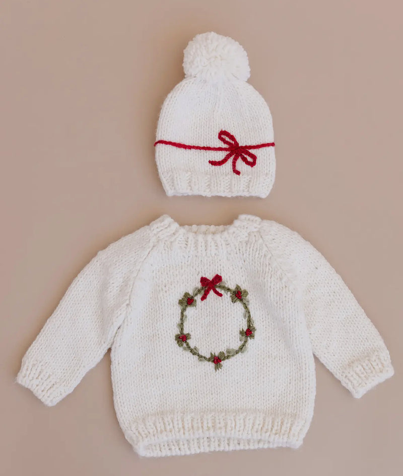 Knitted baby sweater with festive wreath and hat set. 