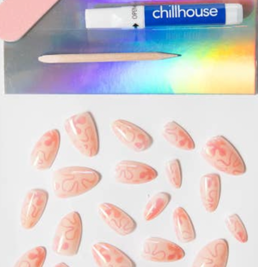 Set of pink nail extensions with a 'Chillhouse' branded box in the background.