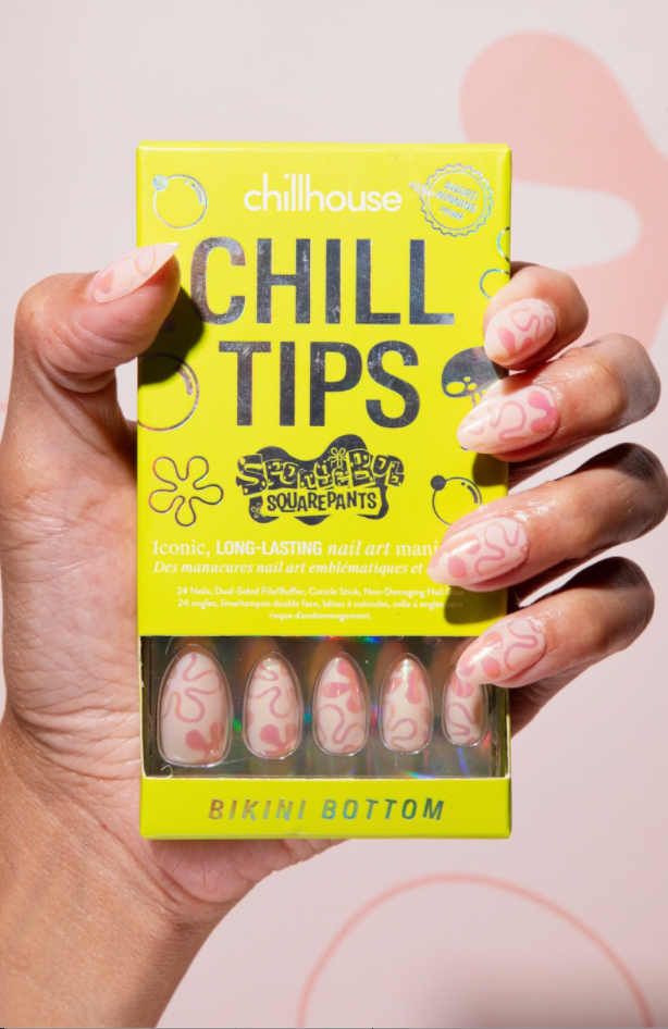 Chill Tips nail art product packaging held by a hand with pink nails.