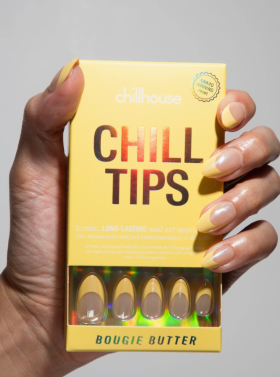 Hand holding a box of 'Chill Tips' with 'Bougie Butter' text on a gray background