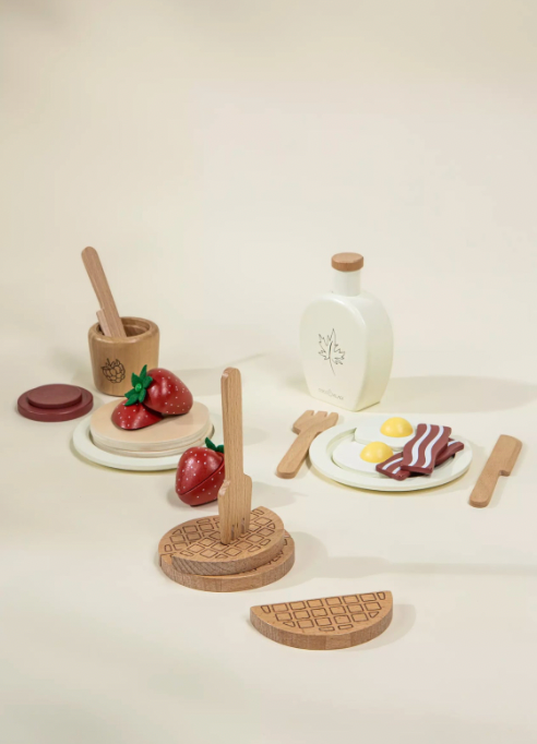 Wooden toy food set on a white background