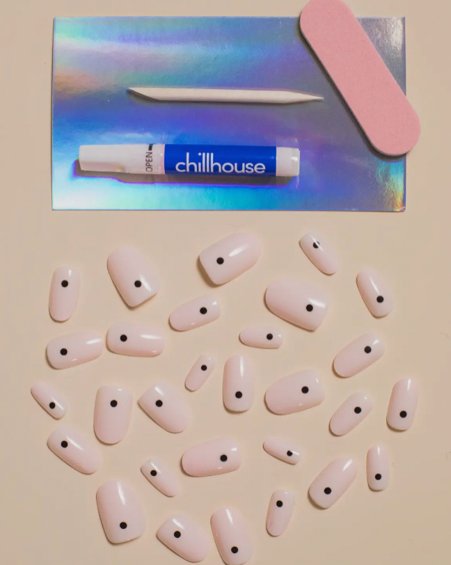 Set of false nails with black dots and a 'Chillhouse' product in the background.