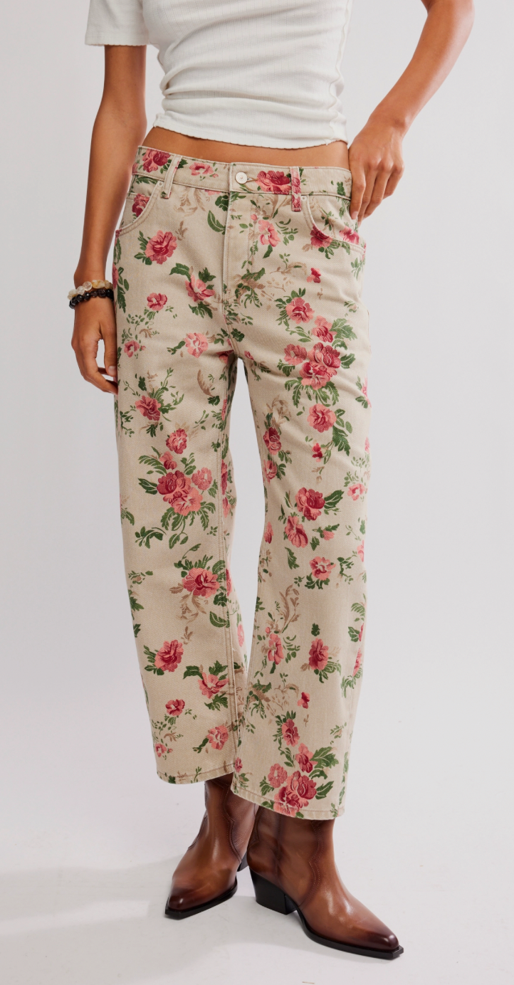 Floral pants worn by a person on a white background