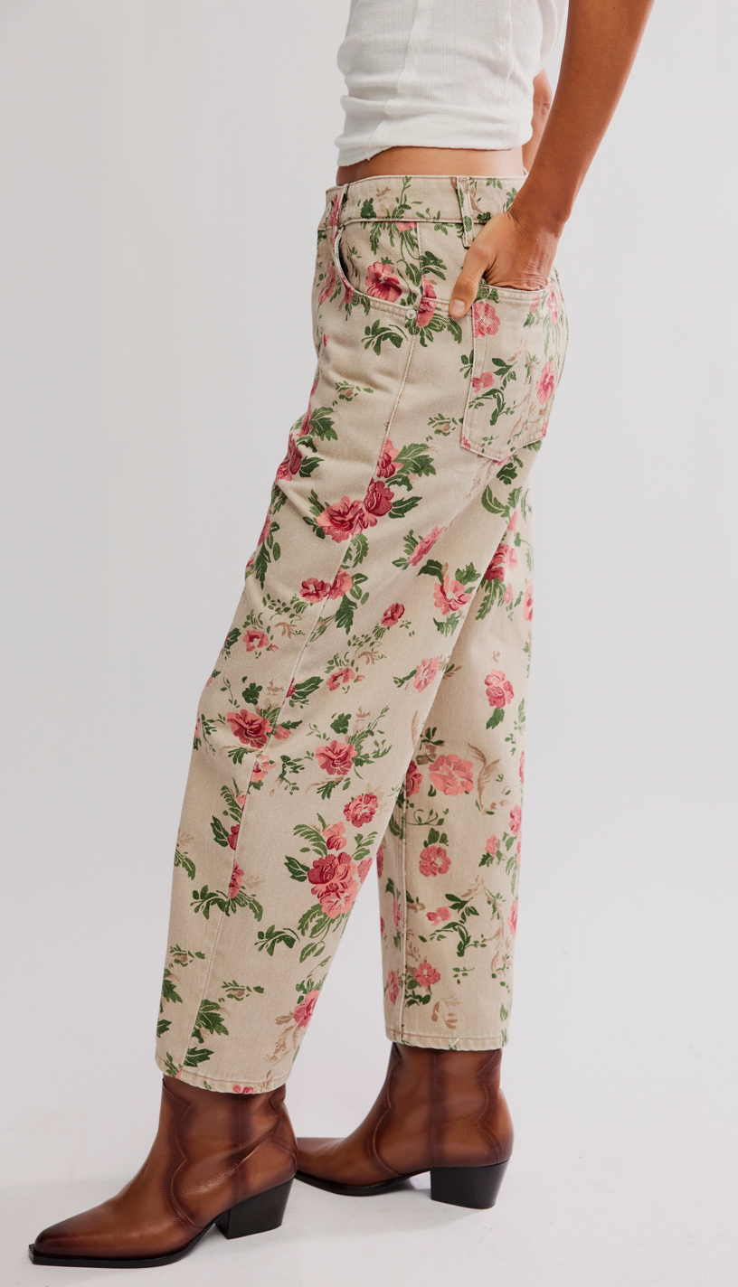 Floral patterned pants worn by a person on a plain background
