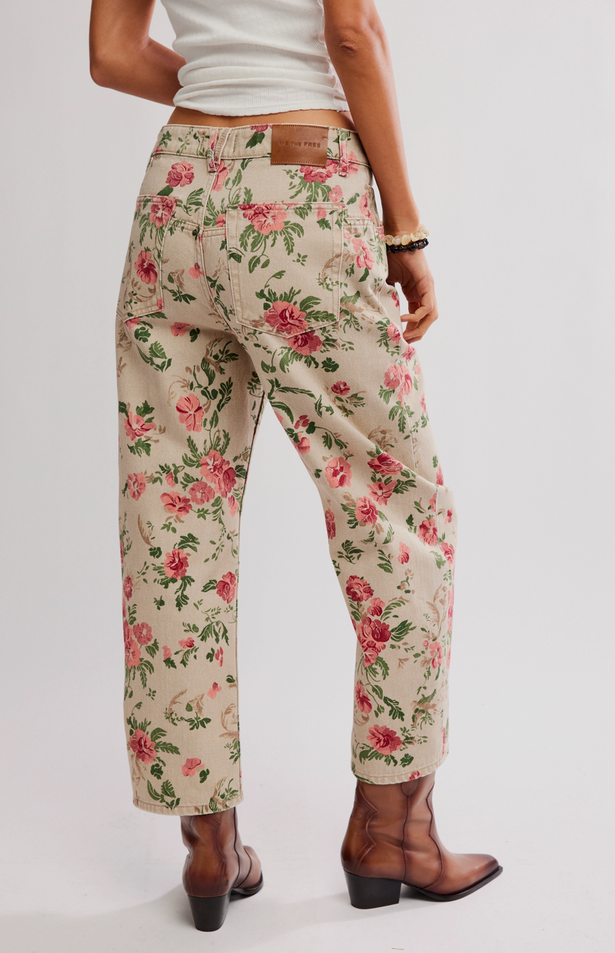Floral pants worn by a person on a white background