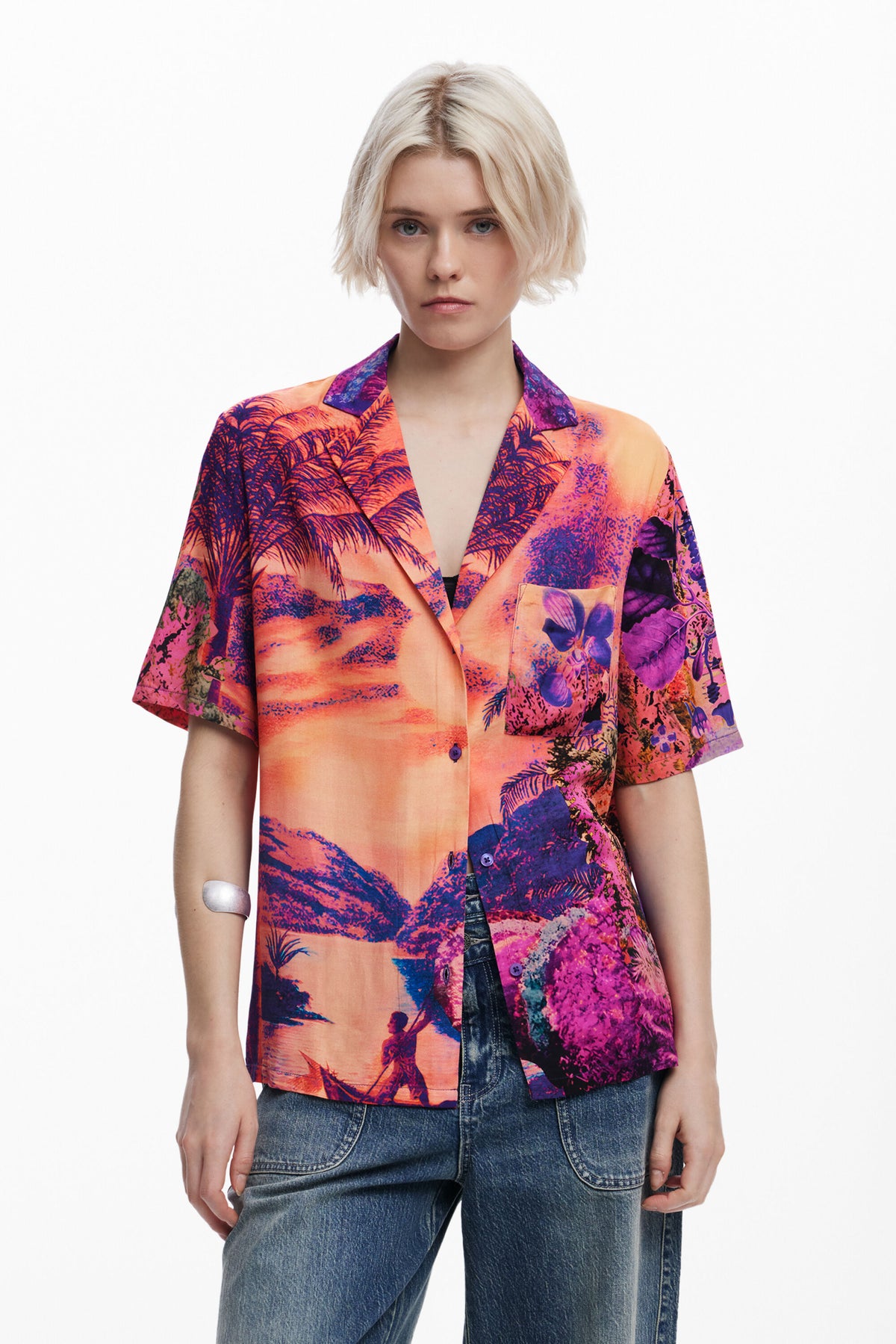 Person wearing a colorful patterned shirt with a white background