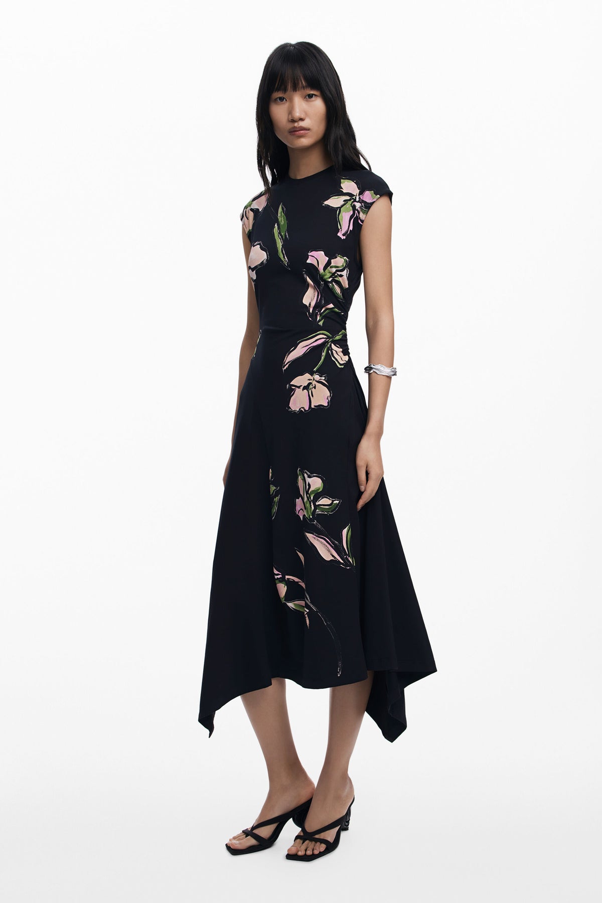 Woman wearing a black floral dress on a white background