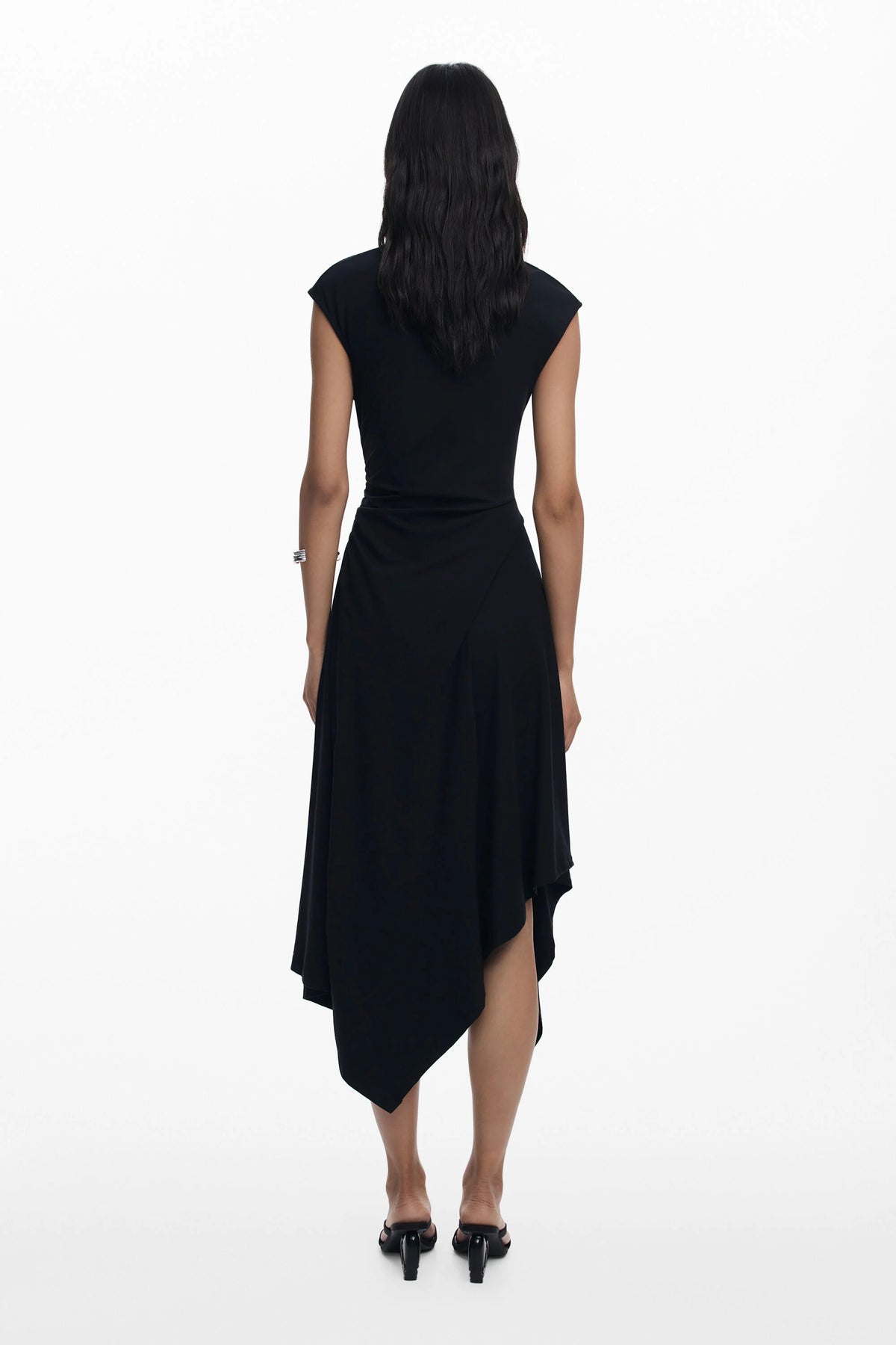 Black dress worn by a person on a white background