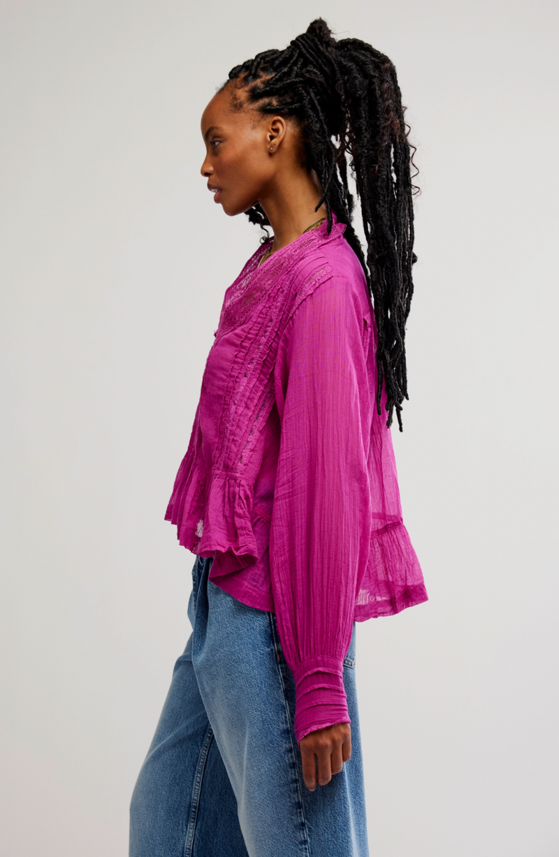 Person wearing a pink blouse and blue jeans on a white background