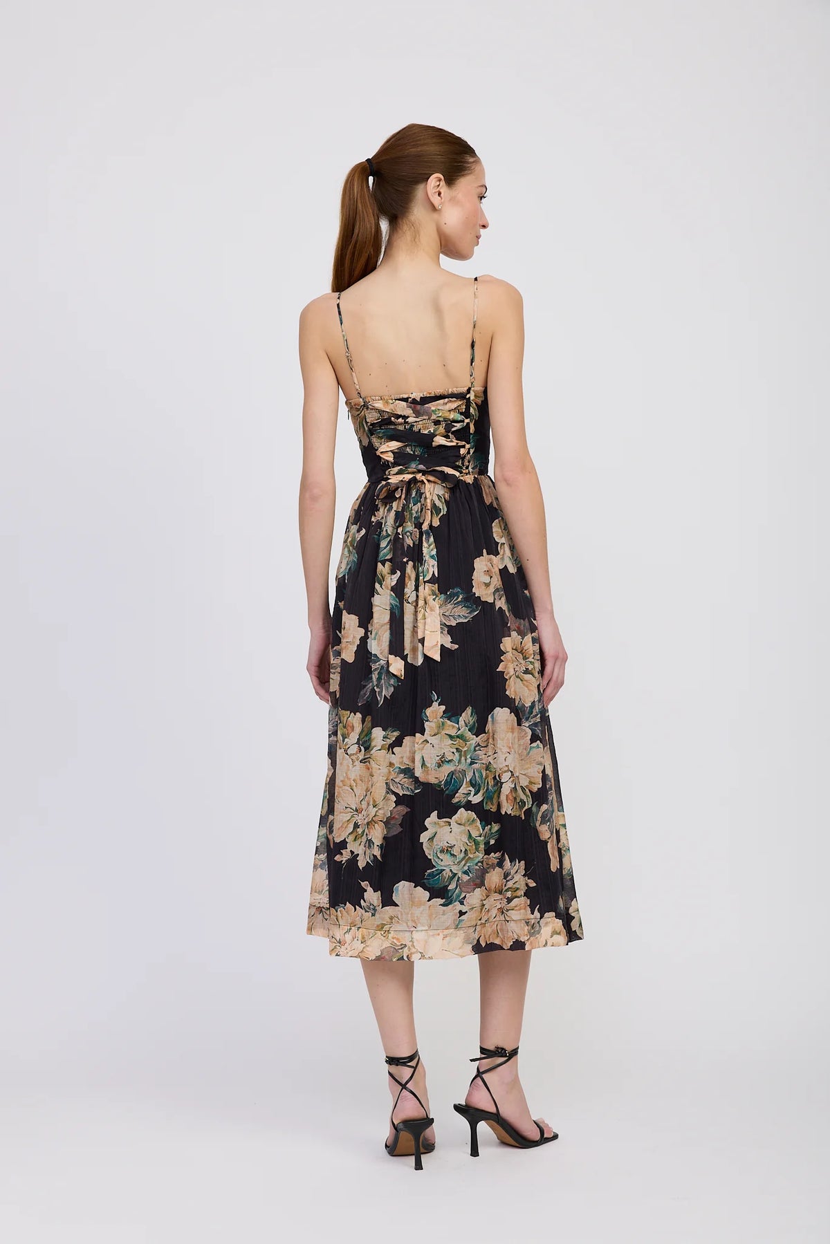 Woman wearing a floral dress on a white background