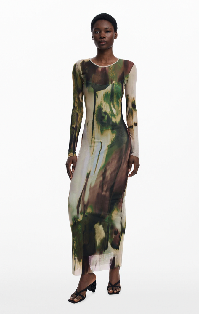Model wearing a long-sleeve dress with a camouflage pattern on a white background
