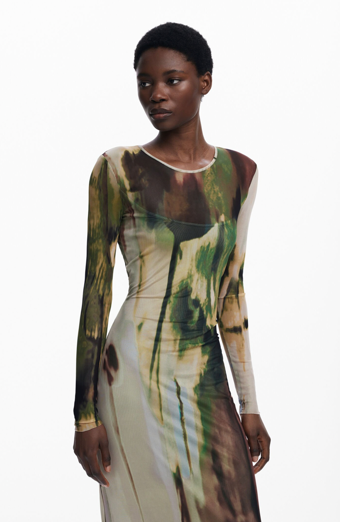 Model wearing a long-sleeve dress with abstract pattern on a white background