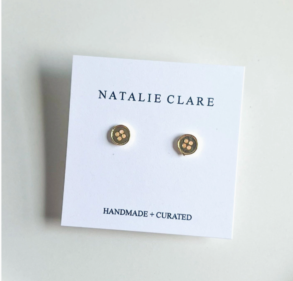 Gold earrings on a 'Natalie Clare' branded card with a white background