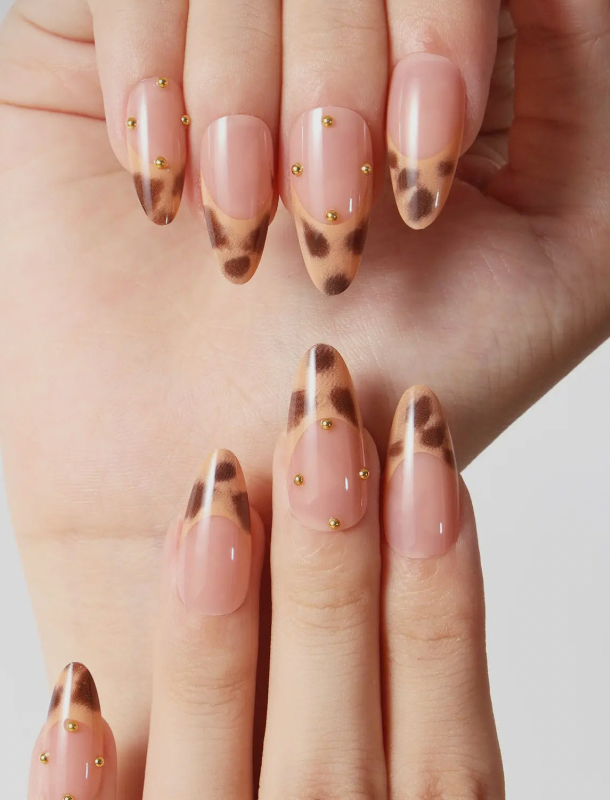 Nails with a leopard print design on a neutral background