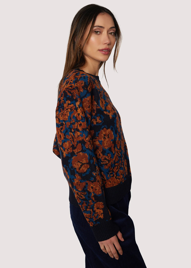 Woman wearing a patterned sweater on a white background