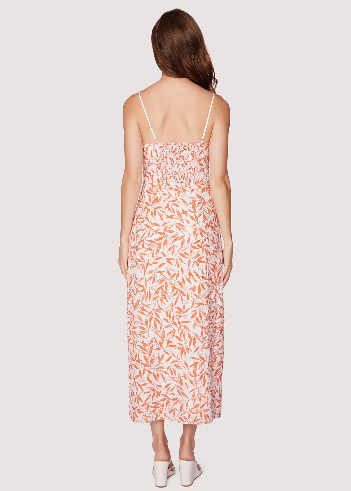 Woman wearing a floral dress on a white background