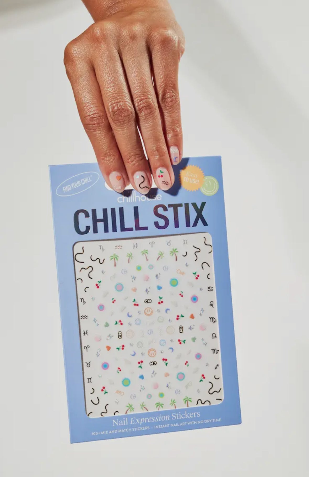 Chill Stix nail expression stickers packaging held by a hand on a light background