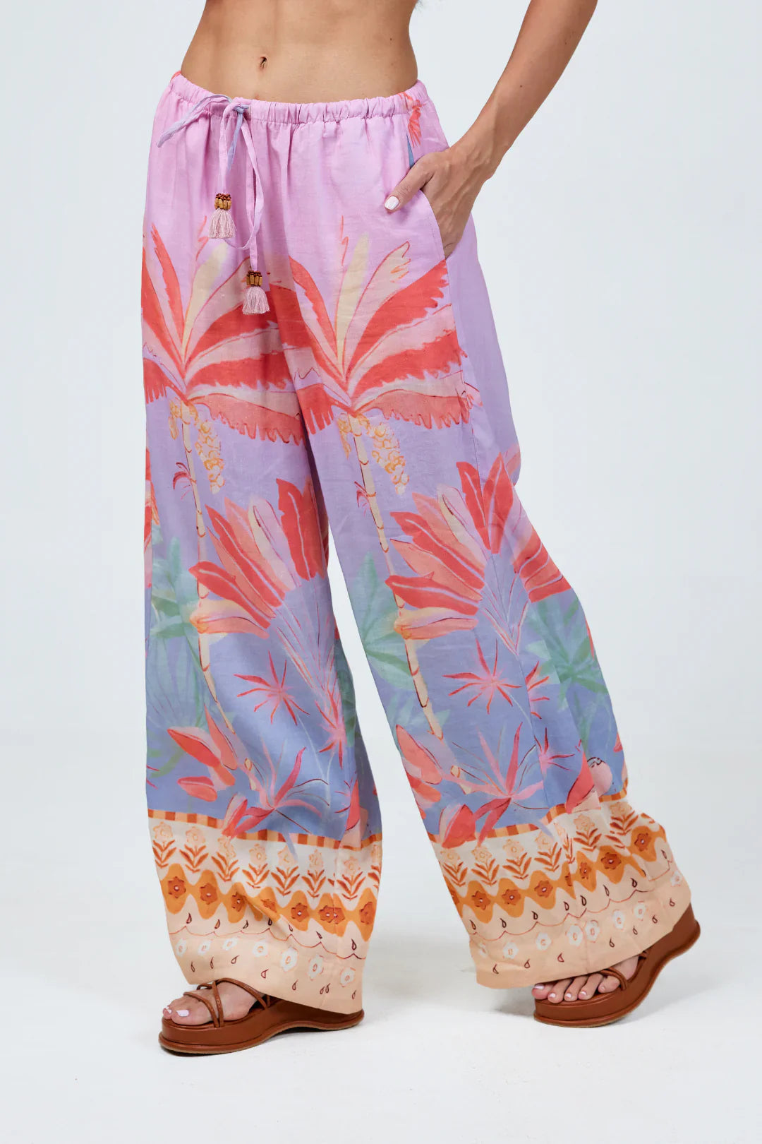 Colorful patterned pants with a tropical design on a white background