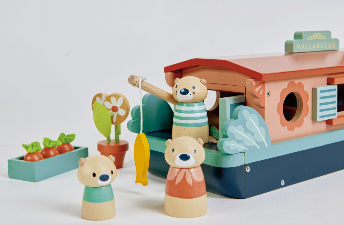 Wooden toy house with teddy bear characters and accessories on a white background