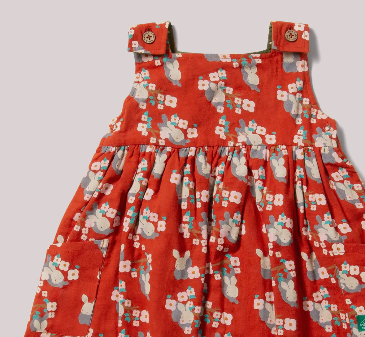 Red floral and bunny patterned dress on a light gray background